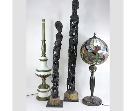 A Tiffany style leaded glass table lamp, 60cm tall, together with another and two African carvings 