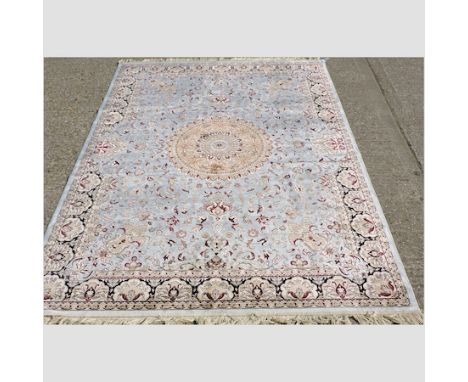 A Keshan carpet, with a central medallion and floral designs, on a light blue ground, 280 x 200cm 