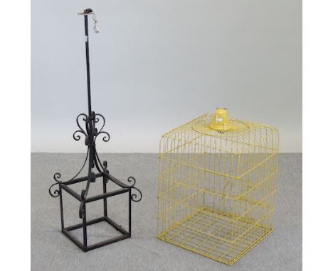 A yellow painted bird cage, 65cm tall, together with a black wrought iron lamp