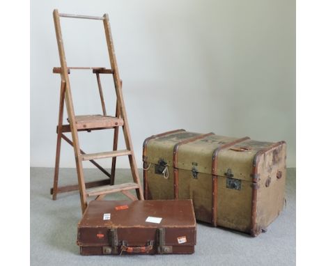 A vintage canvas trunk, 81cm, together with a leather suitcase and a wooden stepladder