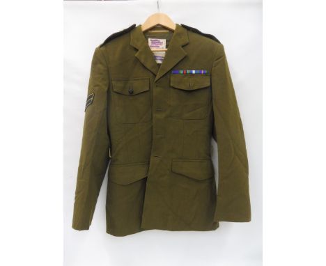 Five British Army tunics with insignias. 
