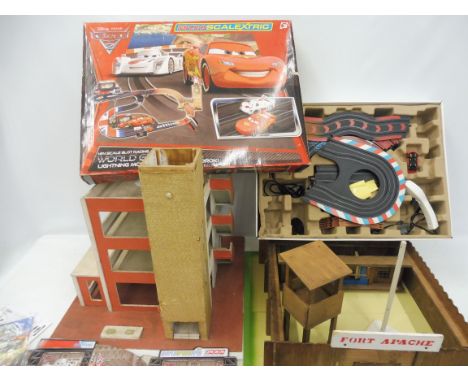 A wooden fort appache, on original play board and a micro scalextric box.