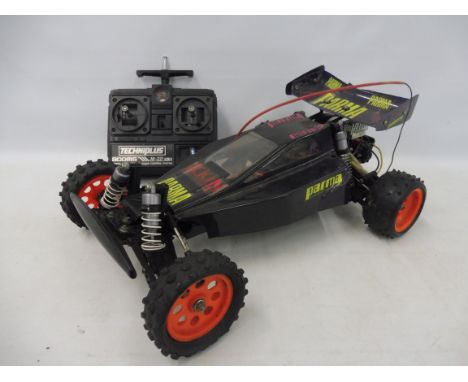 A Tamiya Madcap 58082 1/10th scale electric remote controlled buggy circa 1989, a very good clean car with a Parma after mark