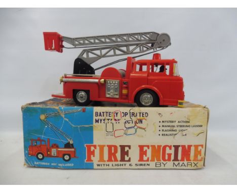 A boxed circa 1960s Marx fire engine, box showing signs of age, model has small damage to side of windscreen.