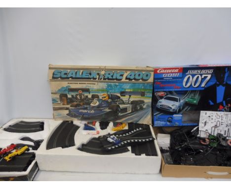 Three slot car sets comprising James Bond 007, Scalextric 400 and Monaco.