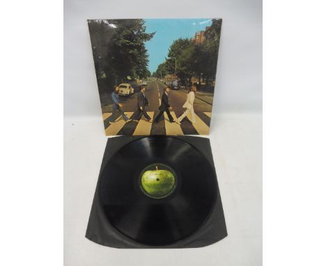 Beatles Abbey Road first press, the apple logo is aligned to the side one track list on rear. With original black inner, ster