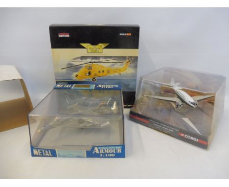 A boxed Corgi Aviation Westland Wessex helicopter, a boxed Corgi Douglas DC3 and an F18 Hornet.