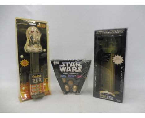 Two large scale Star Wars Pez plus a complete Star Wars Topps candy container. 