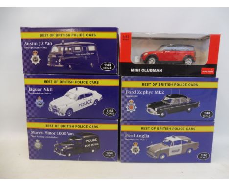 Five 1:43 scale British police cars and one other.