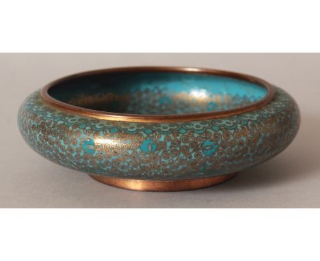 AN EARLY 20TH CENTURY CHINESE TURQUOISE GROUND CLOISONNE BOWL, the foliate decoration mainly formed from scroll-form cloisons