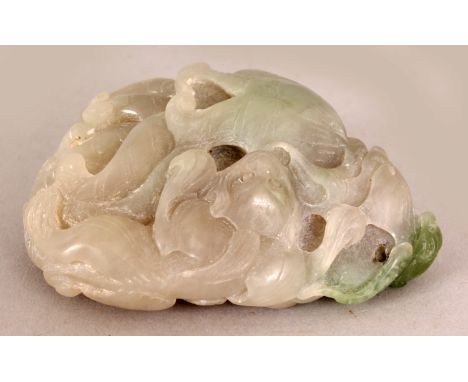 AN EARLY 20TH CENTURY CHINESE GREY JADE BOULDER CARVING, in the form of chilong, lingzhi, a bat and finger citron on a lotus 