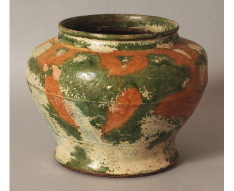 AN UNUSUAL CHINESE HAN STYLE GREEN & OCHRE GLAZED IRIDESCENT CERAMIC JAR, the base unglazed, 6.6wide at widest point & 5in hi