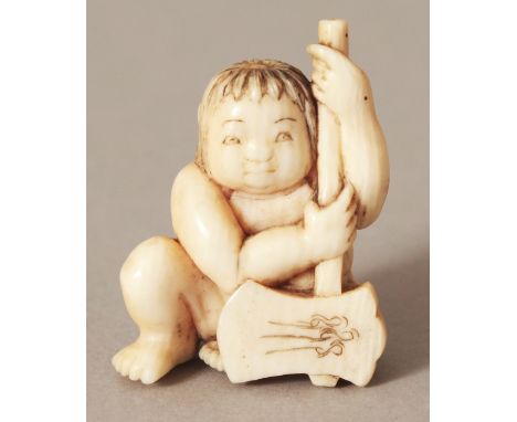 A SIGNED JAPANESE MEIJI PERIOD IVORY NETSUKE OF A SEATED CHILD, bearing an axe, the base with an engraved signature, 1.25in h