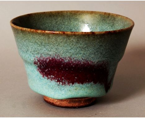 A CHINESE SONG STYLE JUNYAO CERAMIC TEA BOWL, the pale blue glaze falling short of the unglazed foot and applied with purple 