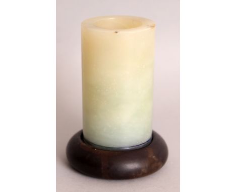 A CHINESE CELADON JADE BRUSHPOT, with fitted wood stand, 4.3in high overall, the brushpot itself 2.1in diameter & 3.6in high.