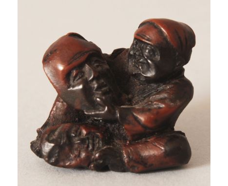 A JAPANESE MEIJI PERIOD CARVED WOOD NETSUKE OF A MASK MAKER, 1.3in wide & 1.2in high.