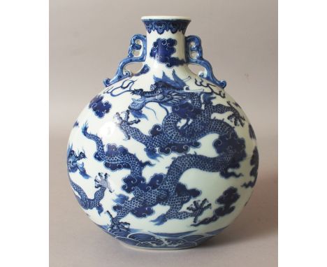 A CHINESE MING STYLE BLUE & WHITE PORCELAIN MOON FLASK, decorated with dragons above stylised waves, the base with a Qianlong