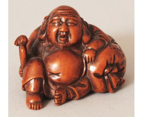 A JAPANESE CARVED WOOD NETSUKE OF HOTEI, seated reclining against his large bag, 1.9in wide & 1.2in high.