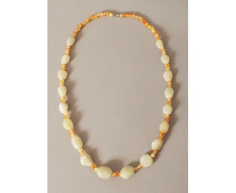 A CHINESE CELADON JADE & AGATE BEAD NECKLACE, the boulder-form jade beads each carved with a mask, approx. 28in long.