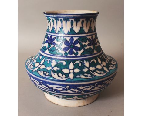 A NORTH AFRICAN ISLAMIC CERAMIC VASE, decorated with formal bands of foliage in turquoise, green and blue, 8.8in wide at wide
