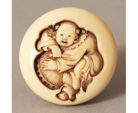 A GOOD QUALITY SIGNED JAPANESE MEIJI PERIOD IVORY MANJU NETSUKE, deeply carved in relief with a boy and a drum, the base with