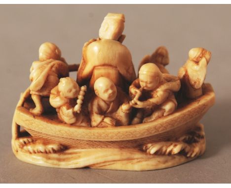 A GOOD QUALITY JAPANESE MEIJI PERIOD IVORY NETSUKE OF A RIVER BOAT, unsigned, the craft bearing Daikoku, a monkey, boys, an o