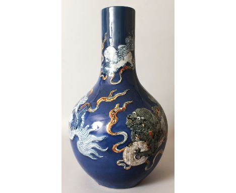 A LARGE 19TH CENTURY CHINESE BLUE GROUND PORCELAIN BOTTLE VASE, the sides decorated in underglaze-blue and enamels in slightl