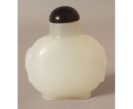 A CHINESE WHITE JADE-STYLE GLASS SNUFF BOTTLE & AUBERGINE GLASS STOPPER, the sides moulded with taotie mask handles, 2.4in wi