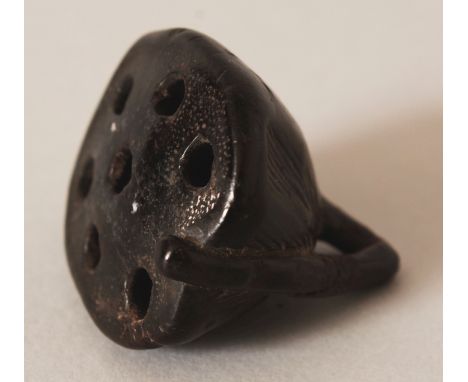 A JAPANESE CARVED WOOD NETSUKE OF A LOTUS POD, 1.4in wide & also 1.4in high.