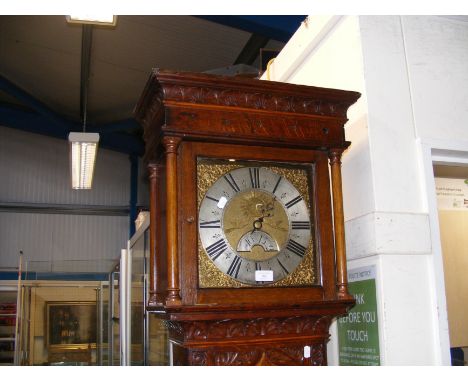 An antique carved oak 30 hour Grandfather clock with rolling date aperture, the silvered chapter ring Thomas Stirling, Barnel