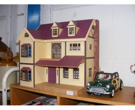 A Sylvanian Families Oakwood Manor House playset with Morris Minor toy car and cat family 