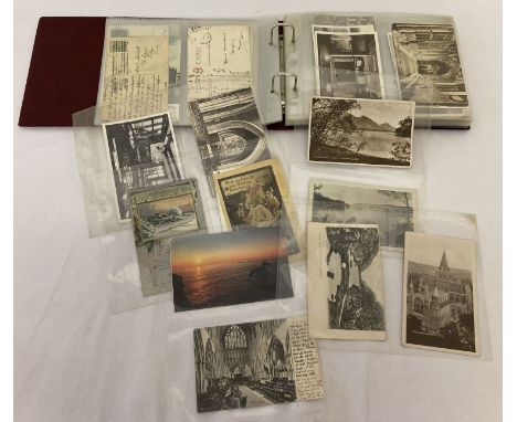 A red album of approx 75 vintage postcards to include hand tinted.Mostly destinations, cathedrals &amp; churches and rural.