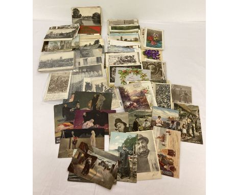 A collection of 100+ antique and vintage postcards and greetings cards. To include: military, Charles Chaplin, Edwardian fish