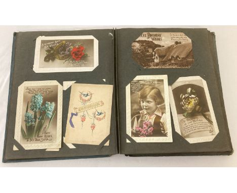 An Art Nouveau album containing approx. 140 antique and vintage postcards &amp; Edwardian photographs. To Include RP's and ha