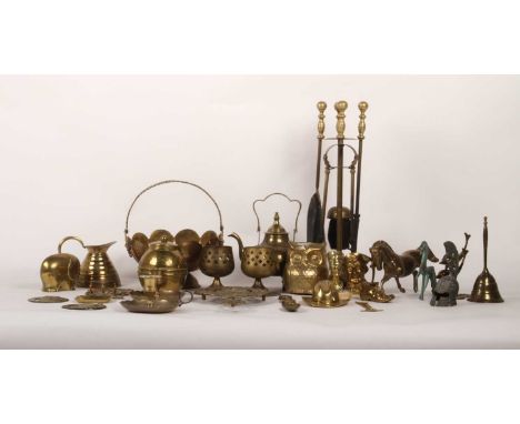 A collection of metalwares, mostly brass, including a teapot, fire tools, and figures