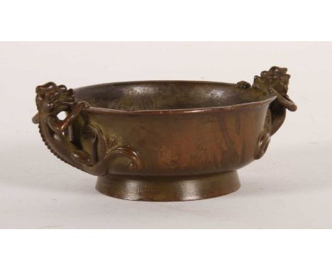 A Chinese bronze censer, flanked by lizard handles, impressed four character mark to the underside, 11cm wide