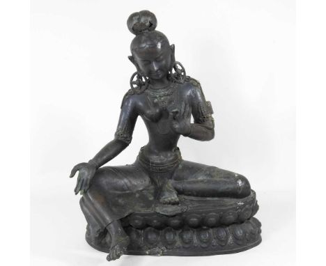 A large Nepalese bronze statue of a deity, shown seated, 50cm high