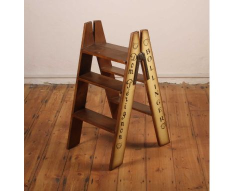 A pair of folding wooden steps, inscribed Dom Perignon, 84cm high
