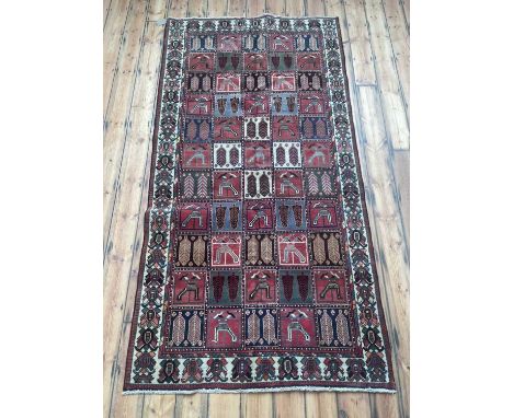 A Persian Bakhtiar carpet, having a panelled ground285 x 150cm