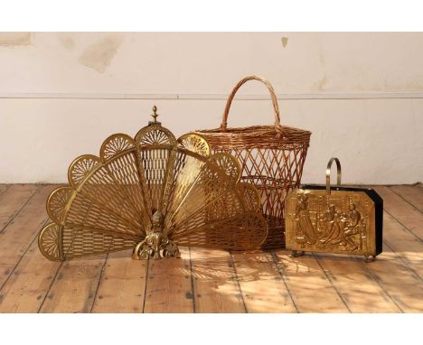 An early 20th century brass folding peacock fire screen, with mask decoration, together with a brass repoussé decorated log h