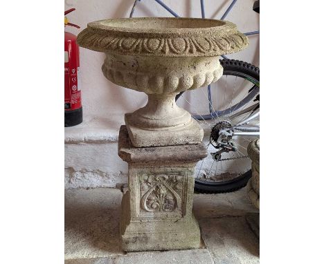 A reconstituted stone garden urn on a plinth62w x 62d x 83h cm