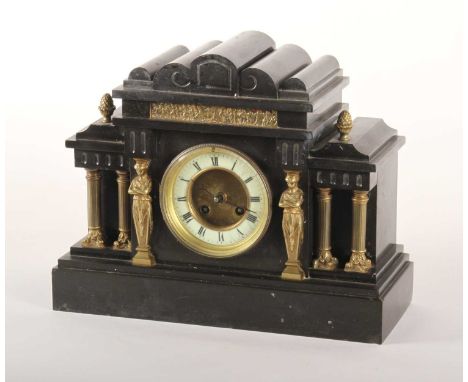 A 19th century black slate mantel clock, of architectural form, having an enamelled chapter ring showing Roman numerals, and 