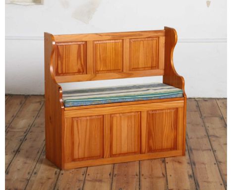 A modern pine pew with a cushion over a hinged seat91w x 34d x 86h cm