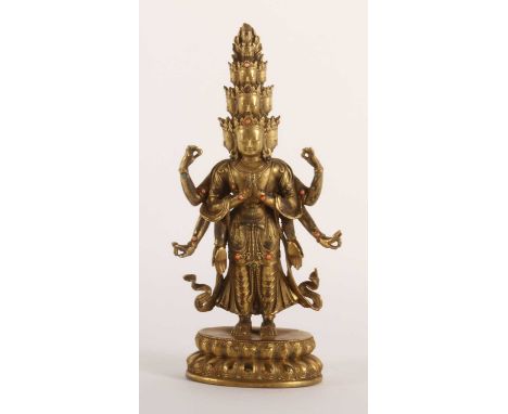 A Chinese gilt bronze figure of the bodhisattva Guanyin, set with cabochons, 27cm high