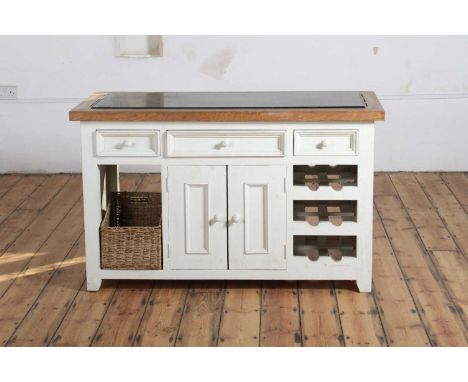A cream painted oak kitchen island, with a polished hardstone worktop, containing three drawers, a cupboard, and a wine rackh