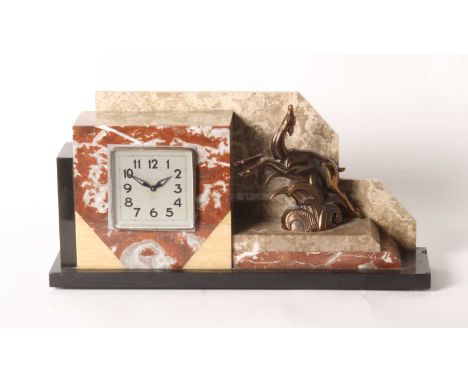An Art Deco polished hardstone mantel clock, surmounted by a leaping deer, with a three inch dialh. 24cm, w. 45cm, d. 11cm
