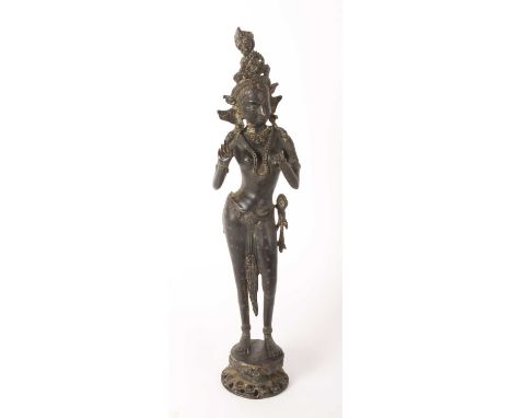 An Asian bronze figure of a Buddhist goddess Tara, shown in standing pose, 52cm high
