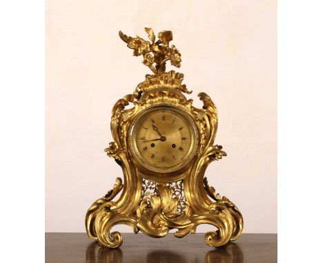 An impressive French ormolu mantel clock, of Rococo style, with an ornate scrolled case, the gilt dial with Roman hours, havi