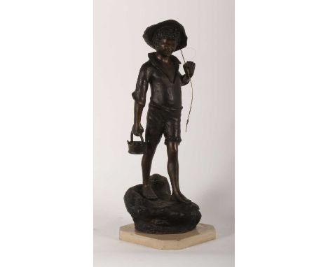A large bronze figure of a boy fishing, shown in standing pose, mounted upon a polished hardstone plinth, 72cm high