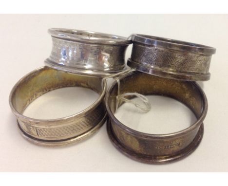 4 Hallmarked silver napkin rings. 3 with engine turned decoration. 